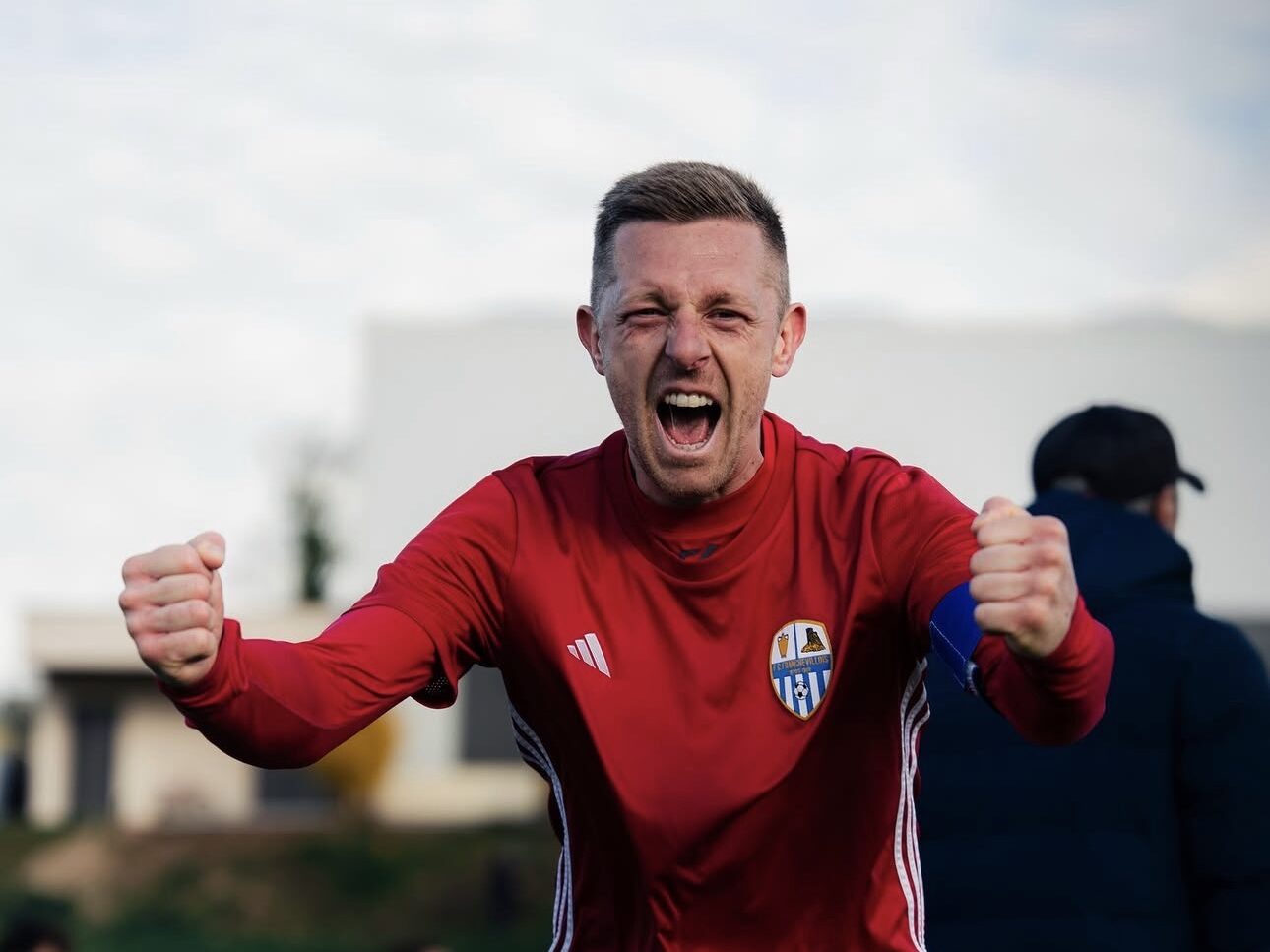 Joueur du FC Franchevillois célébrant une victoire, poings serrés